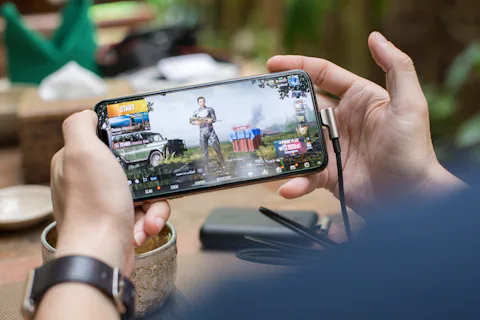 Hands holding a smartphone during a mobile game