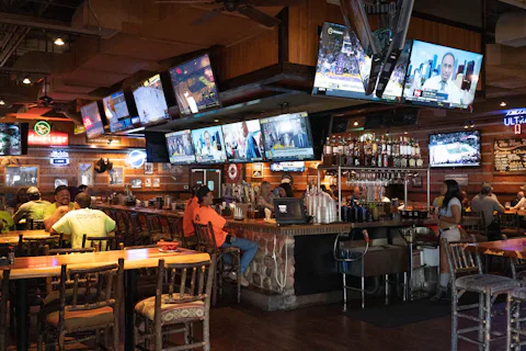 Fans watching live sports on big screens in a bar